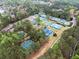 Stunning aerial view of tennis courts surrounded by lush trees and landscaping at 13070 Tidewater Xing, Alpharetta, GA 30005