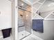 Modern bathroom with glass enclosed shower, marble tile, and blue towels at 13070 Tidewater Xing, Alpharetta, GA 30005