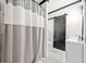 Modern bathroom featuring a shower with stylish curtain, vanity and dark wooden sliding door at 13070 Tidewater Xing, Alpharetta, GA 30005