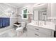 Modern bathroom with decorative wall mirror, toilet, sink vanity, and marble floors at 13070 Tidewater Xing, Alpharetta, GA 30005