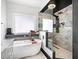 Modern bathroom with shower, soaking tub, and marble tile at 13070 Tidewater Xing, Alpharetta, GA 30005