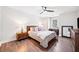 Bedroom with wood floors, ceiling fan, bed, nightstands, and a window at 13070 Tidewater Xing, Alpharetta, GA 30005