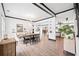 Open-concept dining room with wood floors, neutral walls, and modern lighting at 13070 Tidewater Xing, Alpharetta, GA 30005