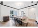 Bright dining room with wood floors, modern lighting, and a large window at 13070 Tidewater Xing, Alpharetta, GA 30005