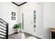 Bright entryway featuring hardwood floors, a white front door with sidelights and clean, white walls at 13070 Tidewater Xing, Alpharetta, GA 30005
