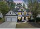Stunning two-story home with elegant black accents, manicured landscaping, and a two-car garage at 13070 Tidewater Xing, Alpharetta, GA 30005