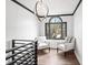 Hallway lounge with black trim, pendant lighting, two white chairs and view from a window at 13070 Tidewater Xing, Alpharetta, GA 30005
