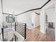 Upstairs hallway with black trim, wood floors, and staircase at 13070 Tidewater Xing, Alpharetta, GA 30005