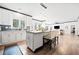 Spacious open concept kitchen with white cabinetry, granite counters, central island and stainless appliances at 13070 Tidewater Xing, Alpharetta, GA 30005
