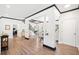 Open-concept living space with wood floors, a staircase, neutral walls, and ample natural light at 13070 Tidewater Xing, Alpharetta, GA 30005