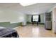 Unfinished basement setup as a bedroom, complete with tile floors and a window at 195 Woodbridge Dr, Dallas, GA 30157