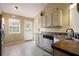 Well-lit kitchen featuring stainless appliances, tile floors, and a double basin sink at 195 Woodbridge Dr, Dallas, GA 30157