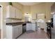 Well-maintained kitchen features white cabinets, updated appliances, and modern countertops, creating a functional space at 195 Woodbridge Dr, Dallas, GA 30157