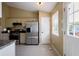 Bright kitchen features stainless steel appliances, tile floors, and granite countertops at 195 Woodbridge Dr, Dallas, GA 30157