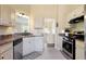 Cozy kitchen features stainless steel appliances, tile floors, and ample cabinet space at 195 Woodbridge Dr, Dallas, GA 30157