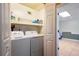 Clean and organized laundry area with modern washer and dryer and built-in shelving unit at 195 Woodbridge Dr, Dallas, GA 30157