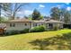Back exterior view of a home featuring a lush, green lawn and patio space at 2123 Juanita St, Decatur, GA 30032