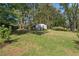 View of the backyard with mature trees and a storage shed at 2123 Juanita St, Decatur, GA 30032