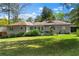 Back exterior view of a home featuring a lush, green lawn and patio space at 2123 Juanita St, Decatur, GA 30032