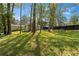 Spacious backyard featuring mature trees, a storage shed, and a picnic table at 2123 Juanita St, Decatur, GA 30032
