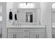 Bathroom featuring dual sinks, sleek white cabinets, and modern lighting at 2123 Juanita St, Decatur, GA 30032