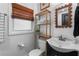 Charming bathroom featuring a dark vanity, sink, modern fixtures, and a window with a bamboo shade at 2123 Juanita St, Decatur, GA 30032
