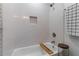 Clean bathroom featuring a soaking tub with a subway tile surround and built-in niche for storage at 2123 Juanita St, Decatur, GA 30032