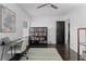 Bright bedroom featuring an office space, hardwood floors, and ceiling fan at 2123 Juanita St, Decatur, GA 30032