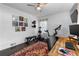 Inviting bedroom with wood floors, modern ceiling fan, exercise equipment, and natural light at 2123 Juanita St, Decatur, GA 30032
