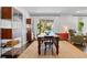 A dining room with shelving, and an outdoor view, offers a versatile space for dining and entertaining at 2123 Juanita St, Decatur, GA 30032