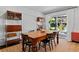 Bright dining room features a wooden table, shelving units, and sliding glass doors to the outdoor living area at 2123 Juanita St, Decatur, GA 30032