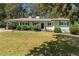 Charming single-story home with a well-maintained lawn, mature trees, and a painted brick facade at 2123 Juanita St, Decatur, GA 30032