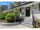 Close up of painted brick home featuring landscaped garden and front door with decorative glass at 2123 Juanita St, Decatur, GA 30032