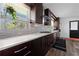 Well-lit kitchen features dark wood cabinets, a white backsplash, and stainless steel appliances, creating a functional and stylish space at 2123 Juanita St, Decatur, GA 30032