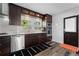 Modern kitchen featuring dark wood cabinets, stainless steel appliances, and a clean white countertop at 2123 Juanita St, Decatur, GA 30032