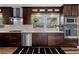 A modern kitchen featuring stainless steel appliances, dark wood cabinets, and a bright window over the sink at 2123 Juanita St, Decatur, GA 30032
