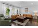 Bright living room boasts hardwood floors, a tan leather couch and a cozy reading nook at 2123 Juanita St, Decatur, GA 30032