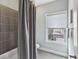 Bathroom features a shower and tub combo with tiled walls and a window at 26 Hardpan Aly, Marietta, GA 30066