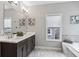 Bright bathroom with double sinks, modern fixtures, a large mirror, and sleek tile flooring at 26 Hardpan Aly, Marietta, GA 30066
