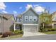 Attractive two-story home featuring a gray exterior, well-manicured landscaping, and a two-car garage at 26 Hardpan Aly, Marietta, GA 30066