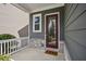 Charming front porch with stone accents, a stylish door, and a cozy 'Home' welcome mat at 26 Hardpan Aly, Marietta, GA 30066
