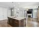 Kitchen island with stone countertop, pendant lights, and bar stool seating at 26 Hardpan Aly, Marietta, GA 30066