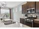 Modern kitchen with stone countertops, stainless steel appliances, and dark wood cabinets at 26 Hardpan Aly, Marietta, GA 30066