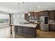Open kitchen features stone countertops, stainless steel appliances, and an island with seating at 26 Hardpan Aly, Marietta, GA 30066