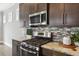 Close up of the kitchen with stainless steel appliances, tile backsplash, and gas range at 26 Hardpan Aly, Marietta, GA 30066