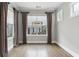 Bright living room featuring hardwood floors, neutral walls, and natural light filtering through the large windows at 26 Hardpan Aly, Marietta, GA 30066