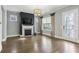 Open living room with fireplace, large window, and stylish light fixture at 26 Hardpan Aly, Marietta, GA 30066