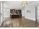 Open living space features hardwood floors connecting the kitchen to the living room at 26 Hardpan Aly, Marietta, GA 30066