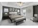 Spacious primary bedroom featuring tray ceilings, accent wall and decorative touches at 26 Hardpan Aly, Marietta, GA 30066