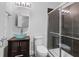 Bathroom showcasing vessel sink, modern vanity, lighted mirror, toilet and tiled shower with glass door at 1029 Piedmont Ne Ave # 102, Atlanta, GA 30309